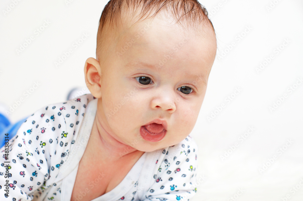 Portrait of the thoughtful baby lying on a stomach (3,5 months) Portrait of the thoughtful baby lying on a stomach (3,5 months)