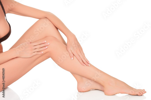 Beautiful woman's legs and hands isolated on white background