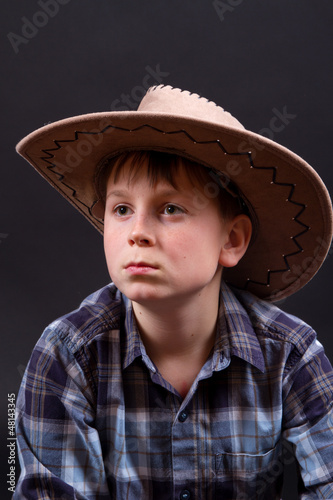 portrait of a boy in a cowboy hat
