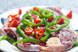 steak with red and green peppers on a plate