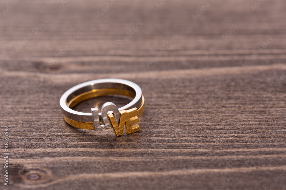 Engagement ring on wooden table Engagement ring on wooden table