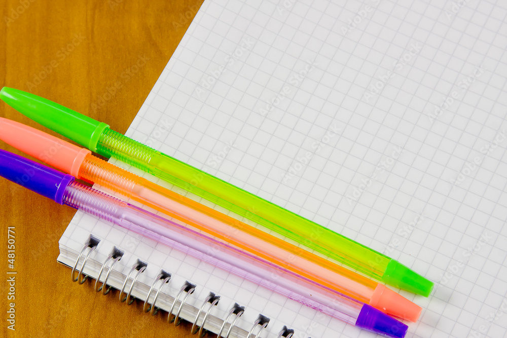 Obraz premium school belonging, notebook and three pens