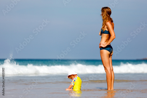 Mother with small baby on the beach photo