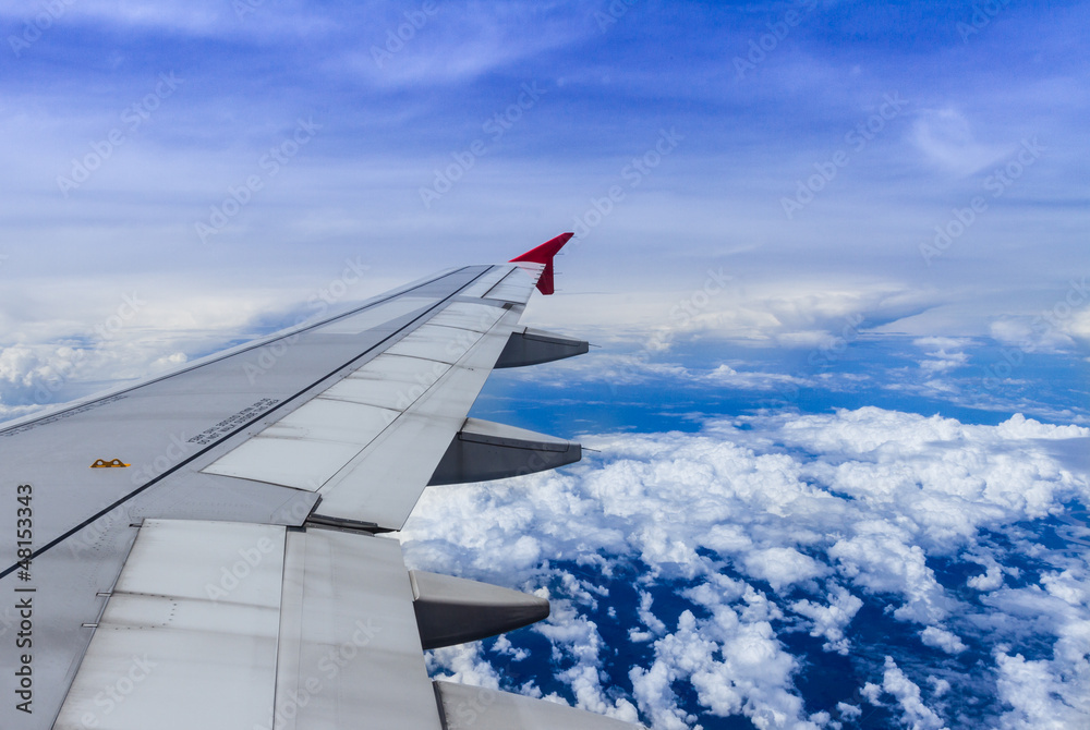 Fototapeta premium Aircraft wing on the clouds,flying background