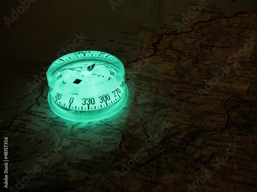 Glowing compass on a map photo