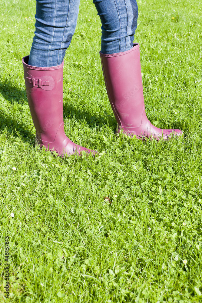 detail of woman wearing rubber boots on lawn
