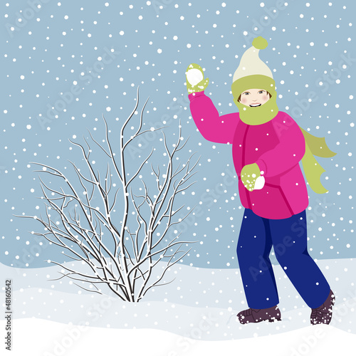 Little girl playing snowballs while it is snowing