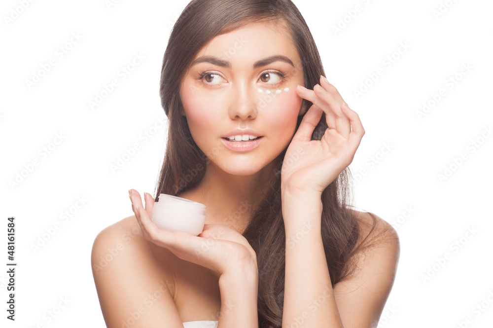 Woman applying moisturizing cream Woman applying moisturizing cream