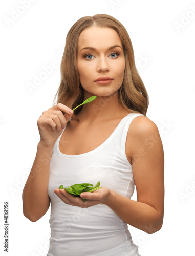 woman with spinach leaves on palms