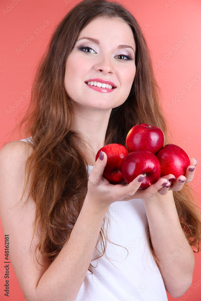 Beautiful woman with apples on pink background Beautiful woman with apples on pink background