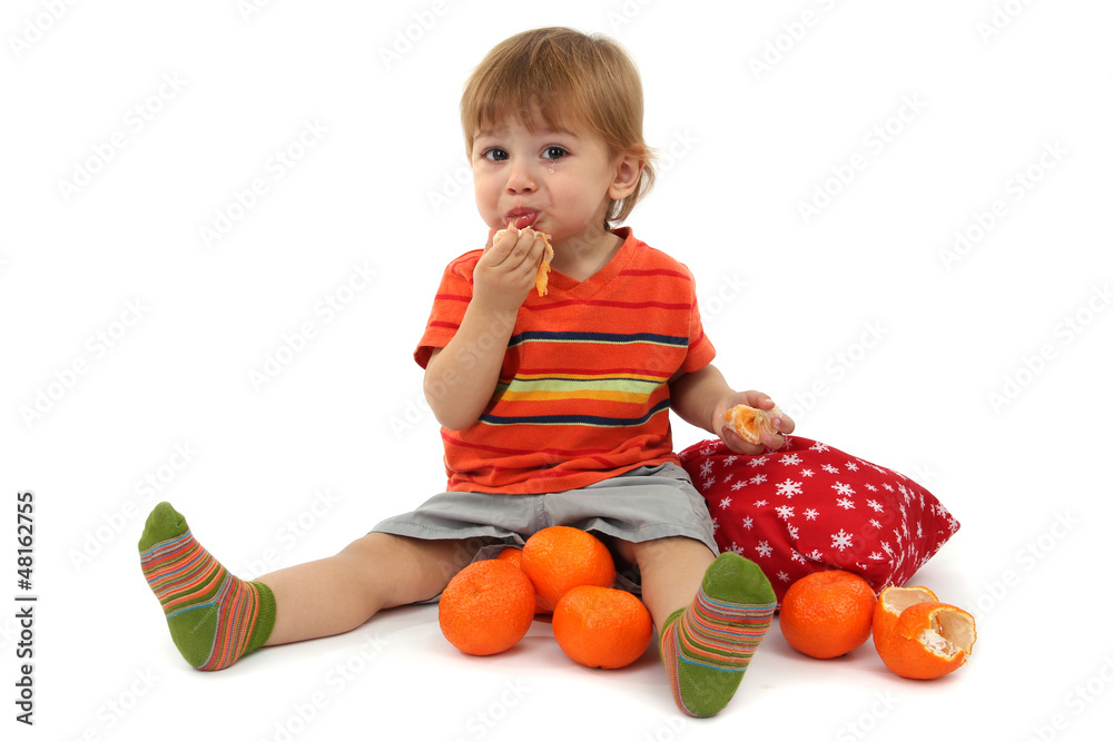 cute little boy eating tangerines, isolated on white cute little boy eating tangerines, isolated on white