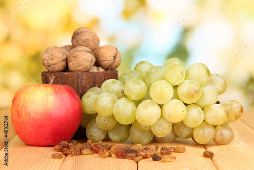 Grape with nuts on wooden table