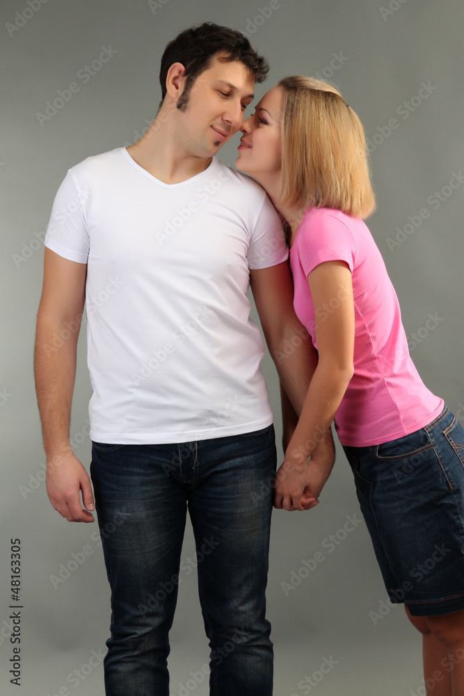 Loving couple on grey background Loving couple on grey background