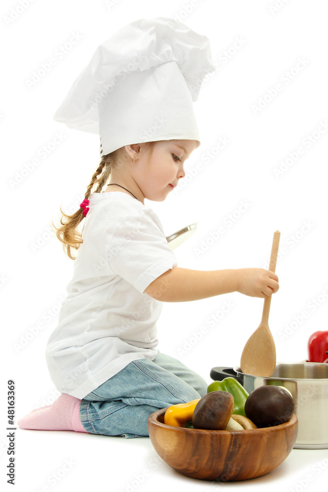 little girl in chef's hat with pan and vegetables, isolated little girl in chef's hat with pan and vegetables, isolated