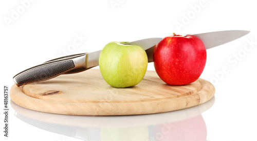 Red, green apples and knife on cutting board, isolated on