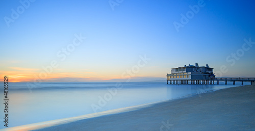 Pier and building on sea and beach. Follonica, Tuscany Italy photo