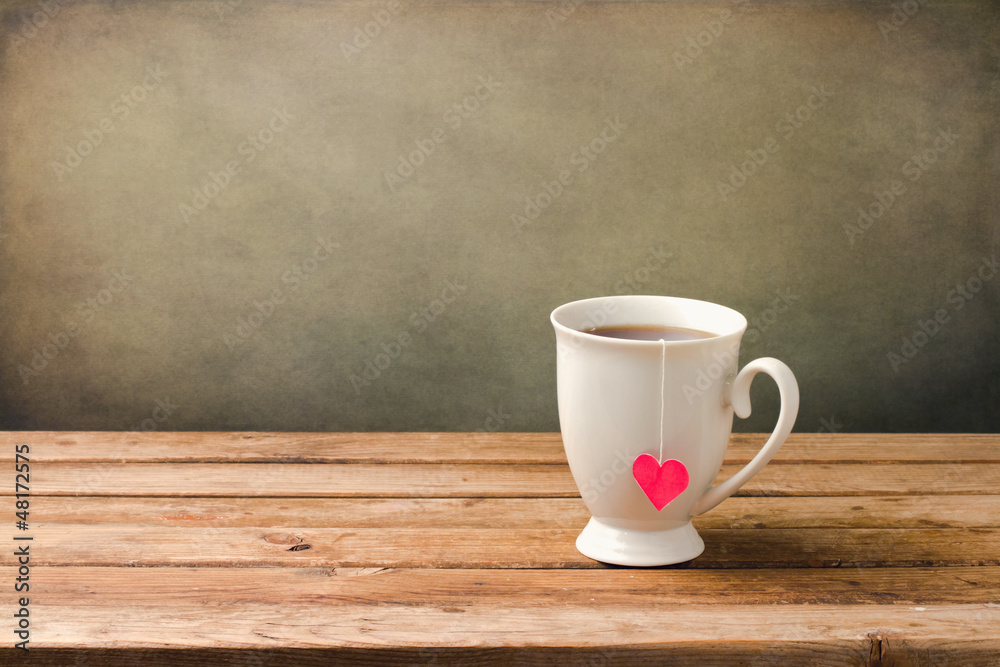 Cup of tea with heart shape on wooden table Cup of tea with heart shape on wooden table