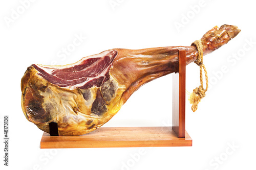 Jamon serrano. A Spanish ham isolated over white photo