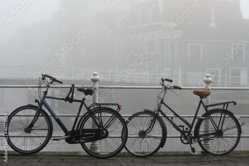 Leiden canal and bicycles in thick fog