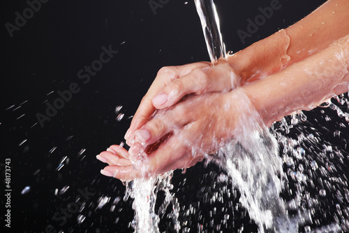 Water falling on female hands