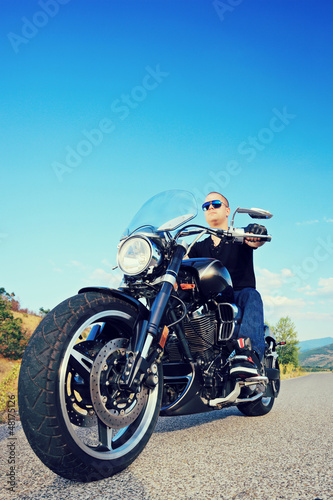 Fototapeta Naklejka Na Ścianę i Meble -  Biker riding a customized motorcycle