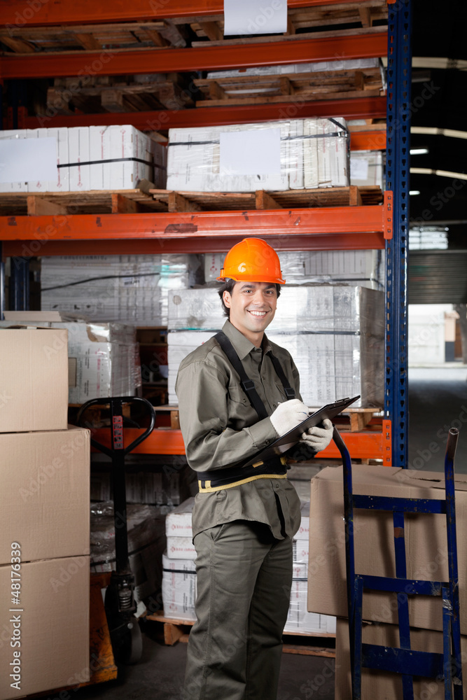 Supervisor Writing On Clipboard At Warehouse Supervisor Writing On Clipboard At Warehouse