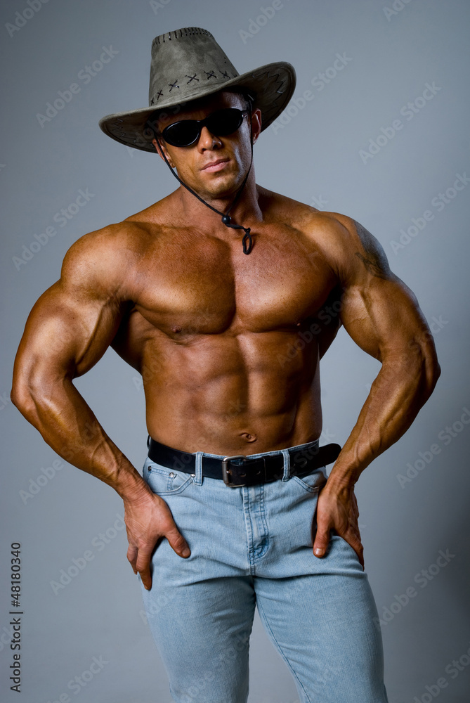 Handsome muscular man wearing a hat and sunglasses Handsome muscular man wearing a hat and sunglasses