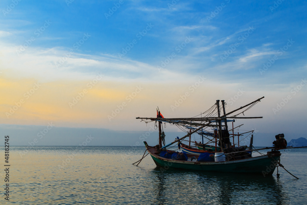 Fishing boats at sunset or sunrise, in Thailand.