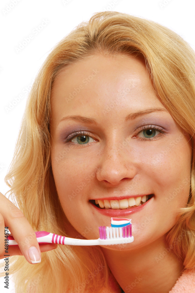 A young woman brushing teeth, closeup A young woman brushing teeth, closeup