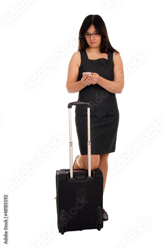Business woman with suitcase and mobile phone