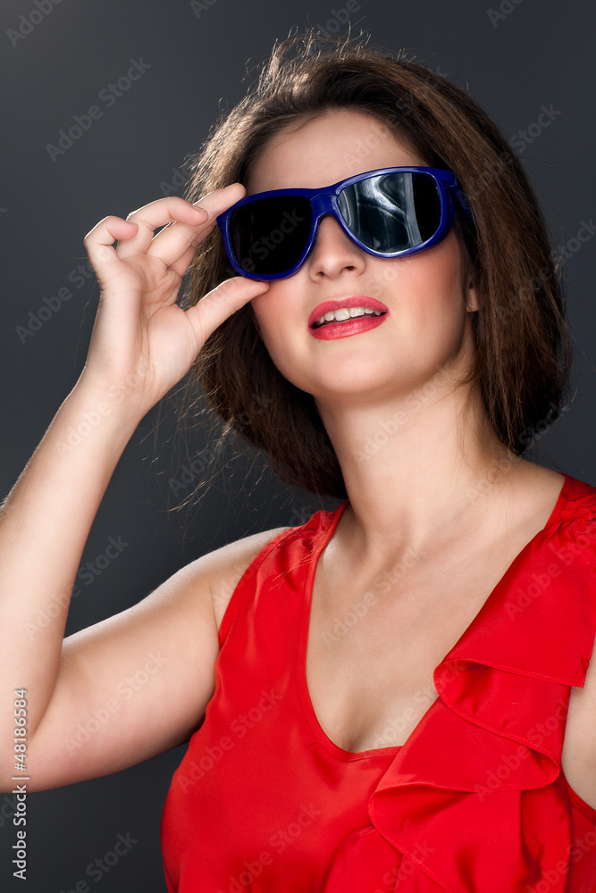 portrait of a beautiful woman in a red dress and glasses portrait of a beautiful woman in a red dress and glasses