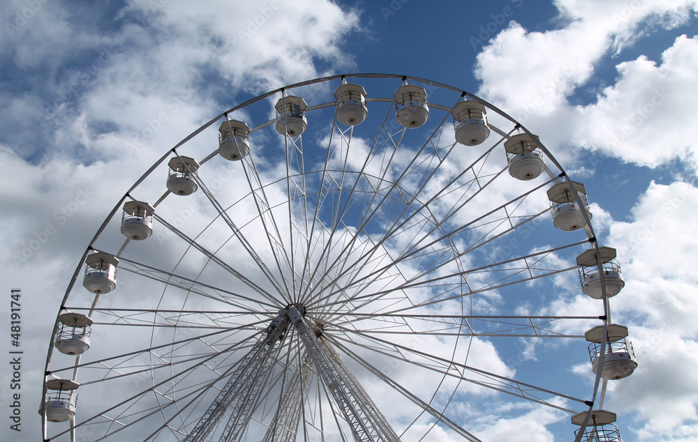 A Fun Fair Big Wheel with a Dramatic Cloud Background.