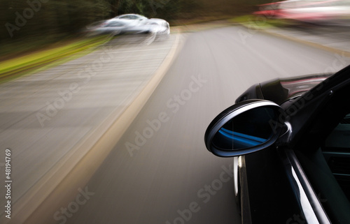 Side view of black car driving fast