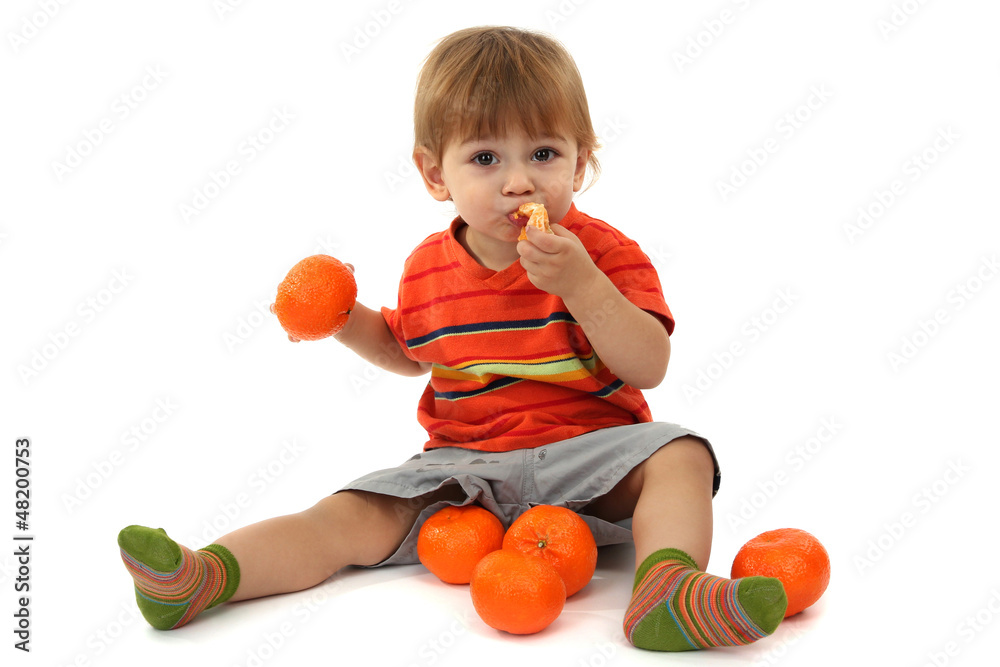 cute little boy eating tangerines, isolated on white cute little boy eating tangerines, isolated on white