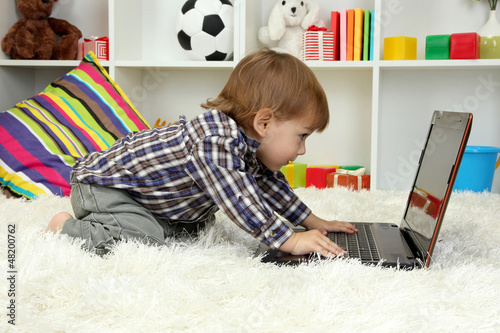 cute little boy and noteboo...