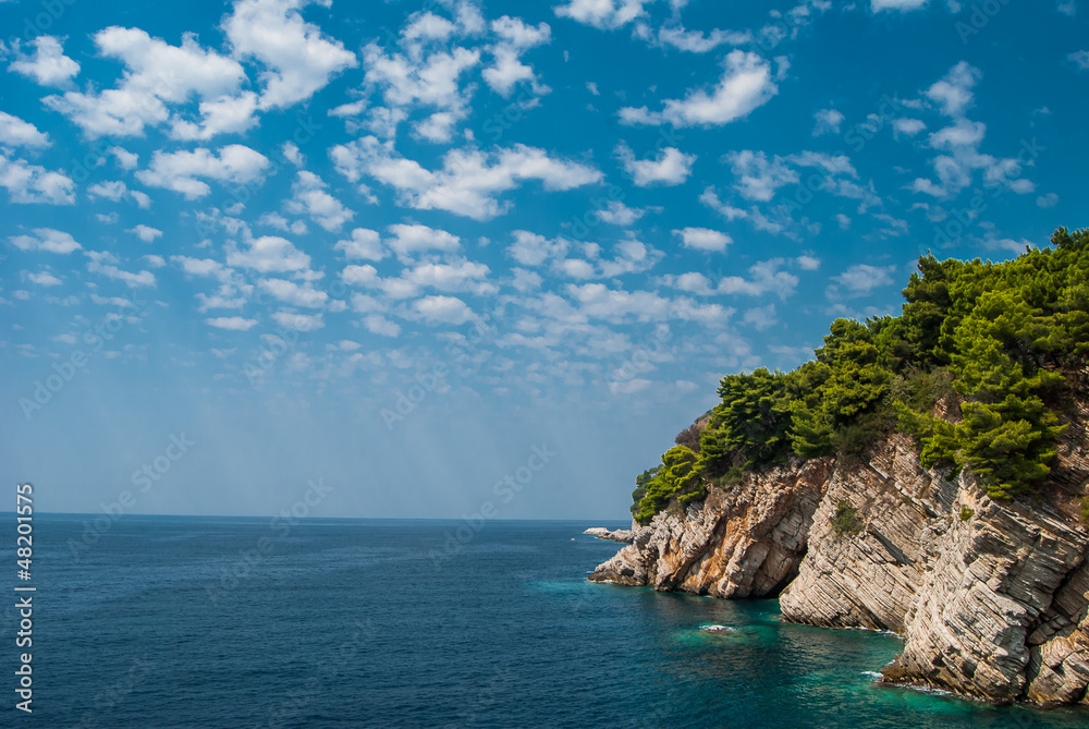 Fototapeta premium Blue sea and sky with cliff and forest