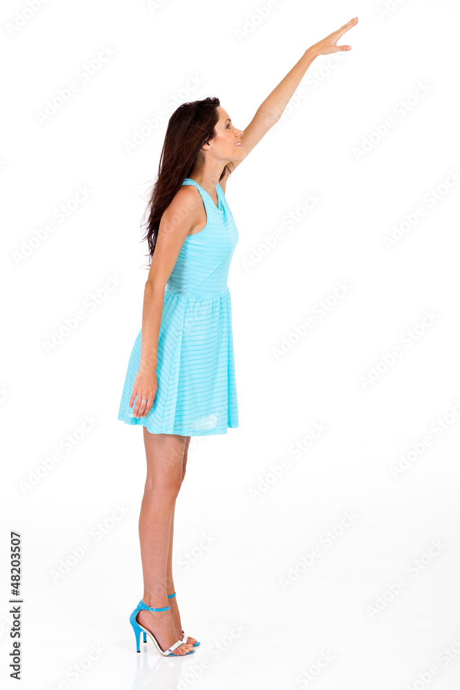 tall young woman reaching for something high