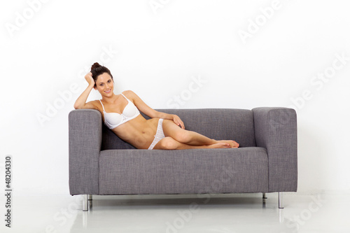 sexy young woman sitting on sofa relaxing