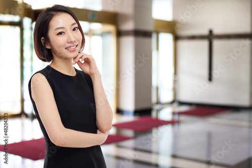 Free Download Yong pretty Asian business woman in business background. - GFXLoad