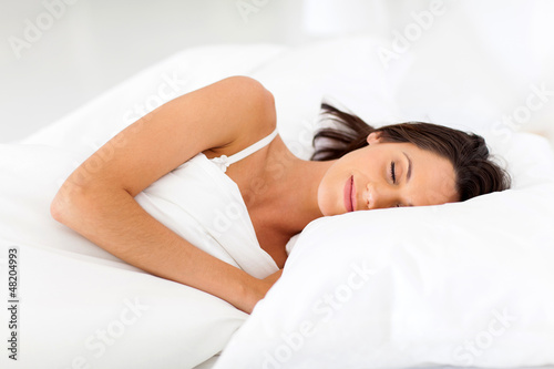 beautiful young having sweet dreams on bed
