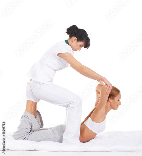 A young redhead woman getting a traditional Thai massage