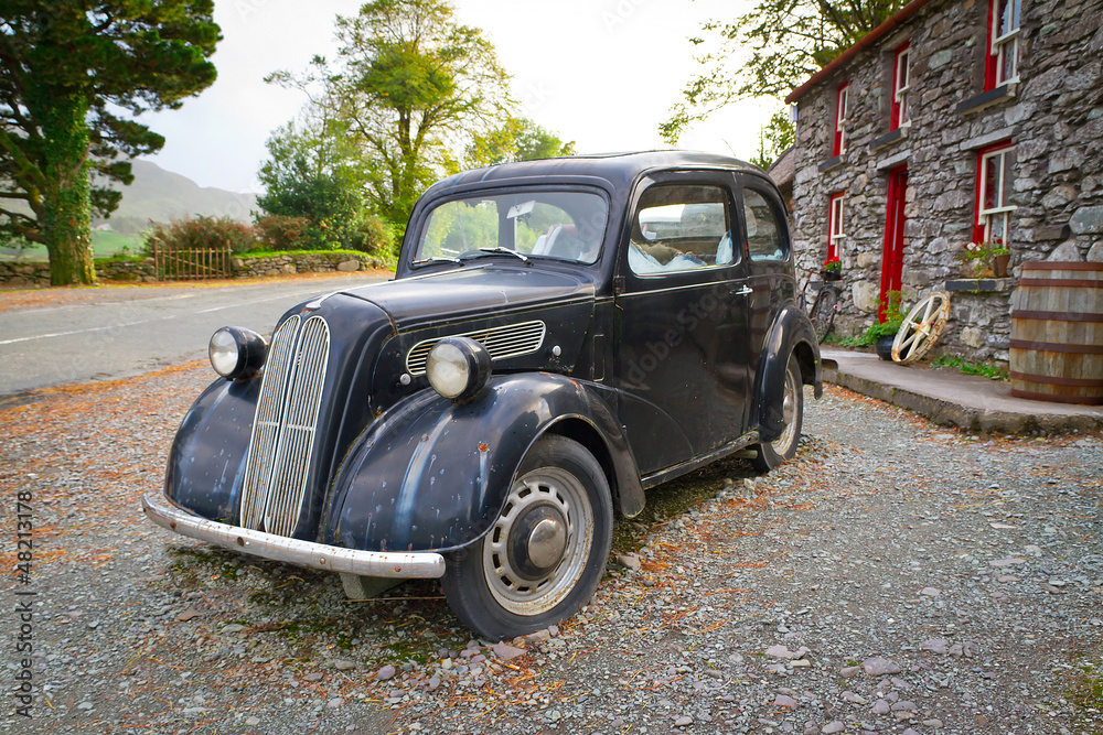 Vintage car on the front of Irish cottage house