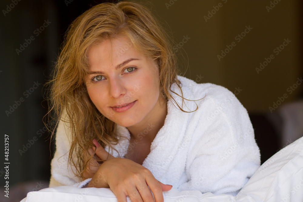 Beautiful blond woman in bathrobe relaxing after bath in a hotel Beautiful blond woman in bathrobe relaxing after bath in a hotel