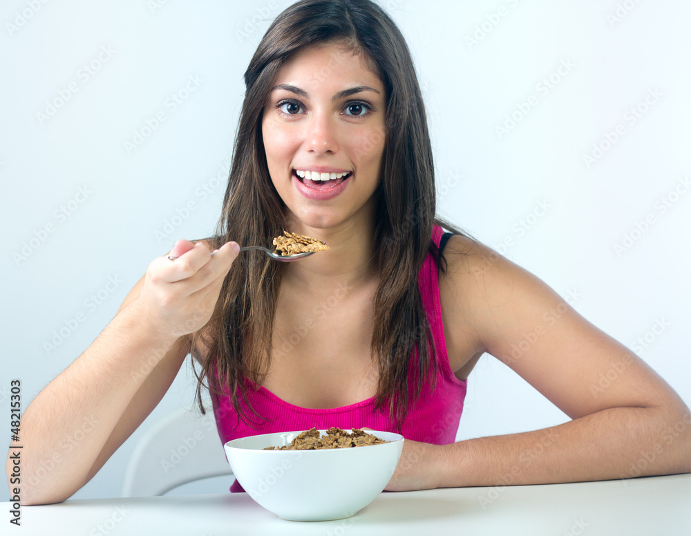 young woman taking a breakfast cereal at home young woman taking a breakfast cereal at home