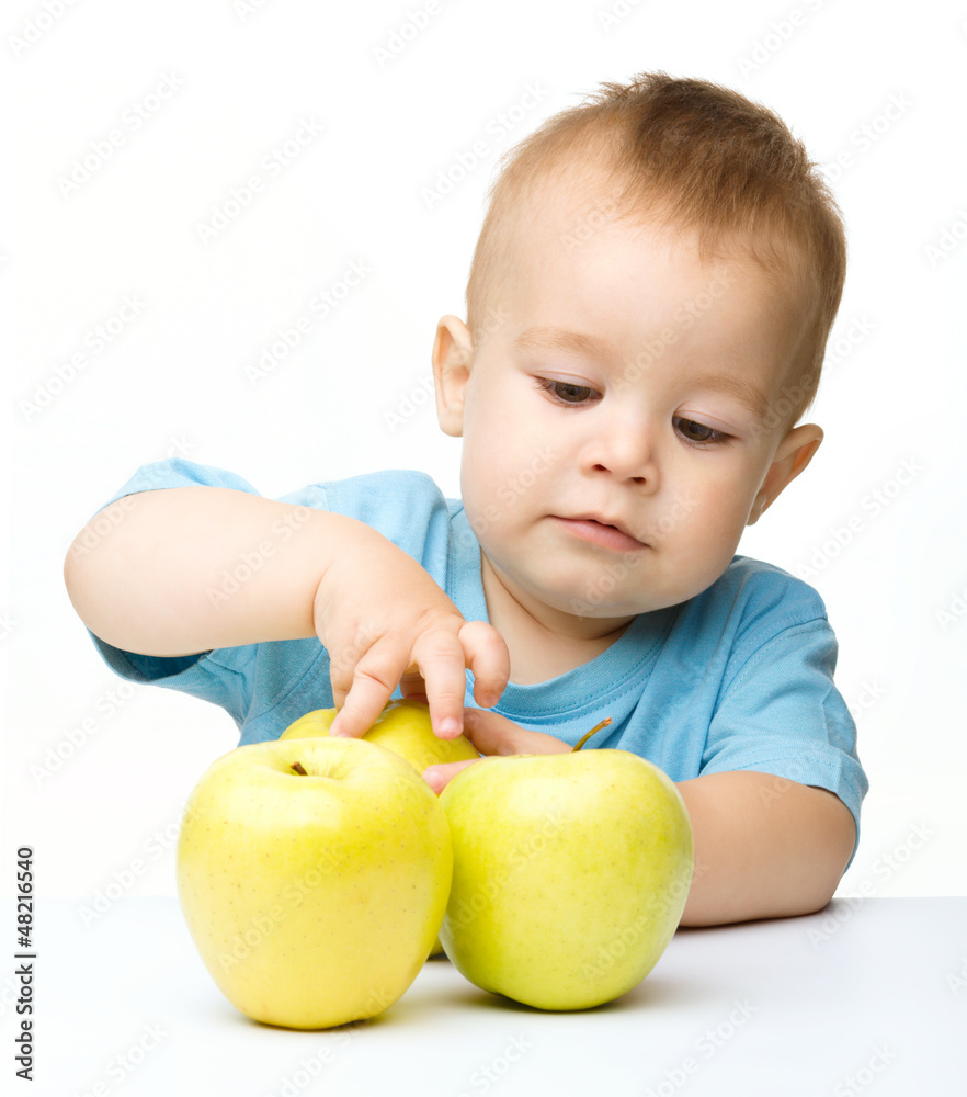 Portrait of a cute little boy with yellow apples Portrait of a cute little boy with yellow apples