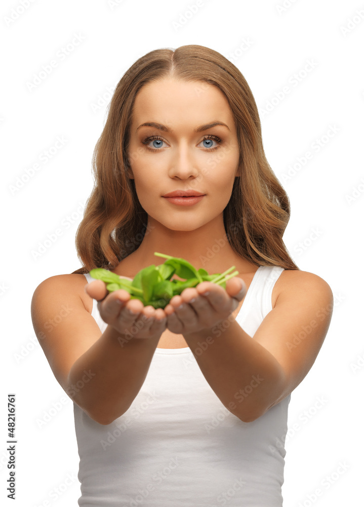 woman with spinach leaves on palms woman with spinach leaves on palms
