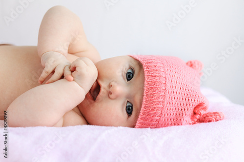 baby girl playing with her small hands
