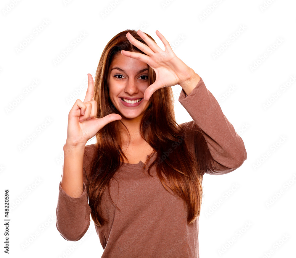 Smiling young woman making a frame with her hands Smiling young woman making a frame with her hands