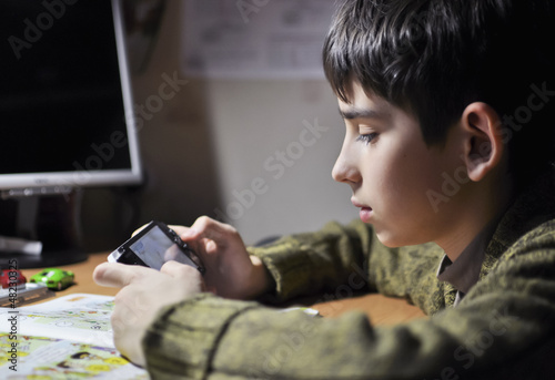 boy is playing psp photo