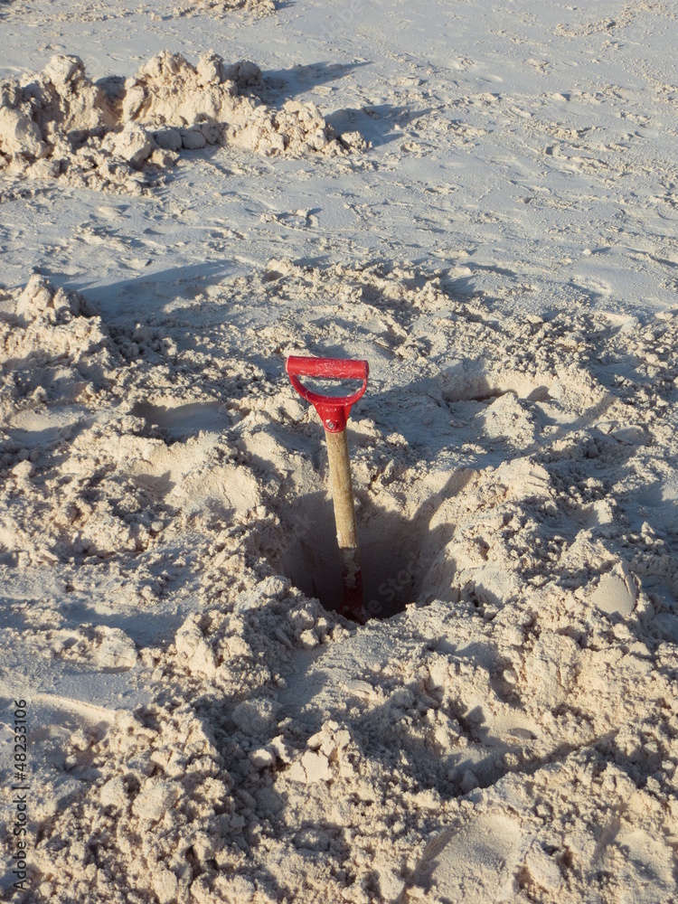 Spade in sand on Caribbean island Spade in sand on Caribbean island